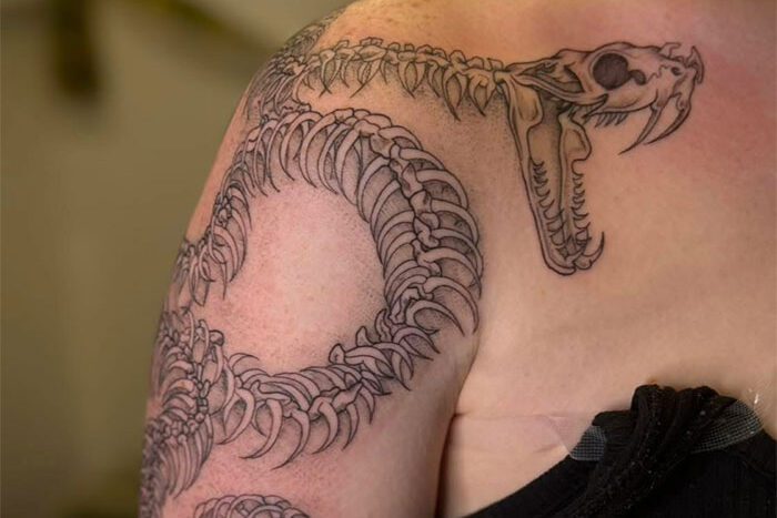Snake skeleton tattoo by Rayne