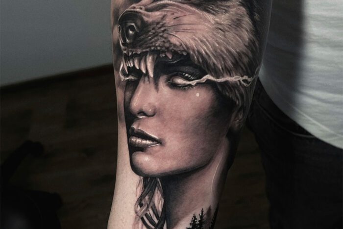 Woman with wolf head hat tattoo