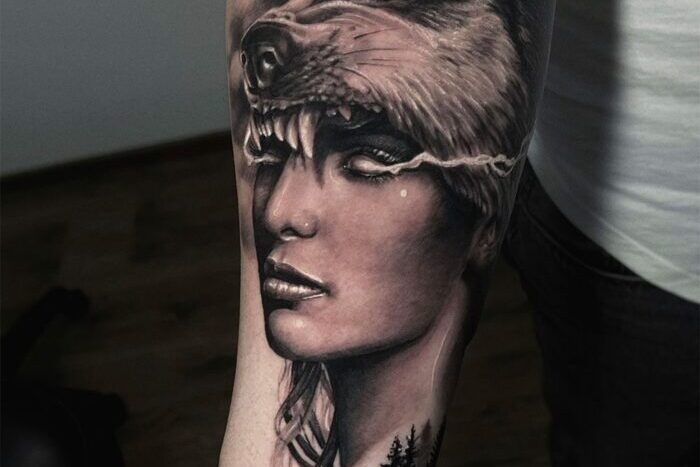 Woman with wolf head hat tattoo by Vladyslav Krasivkov