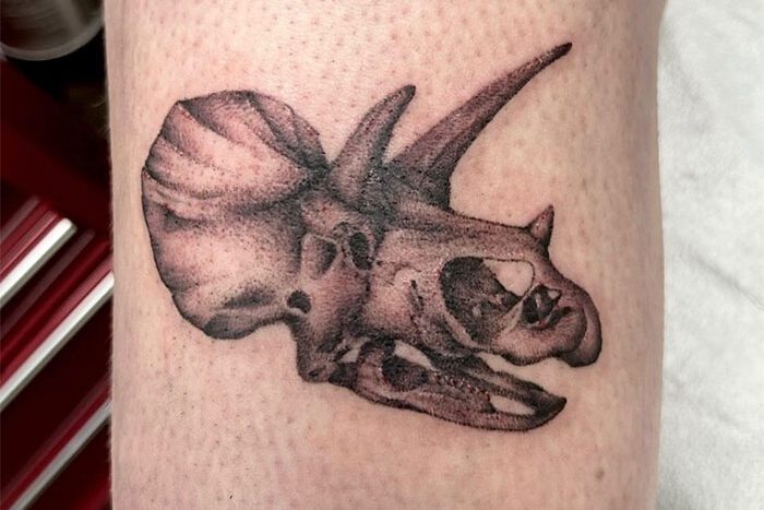 Dinosaur skull tattoo by Kyra Nako
