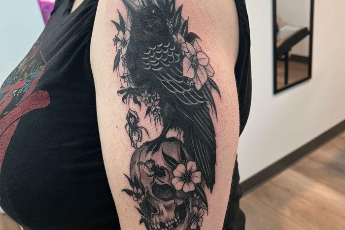 Tattoo of crow, skull and spiders