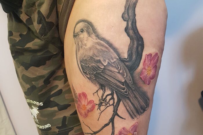 Bird on a branch tattoo