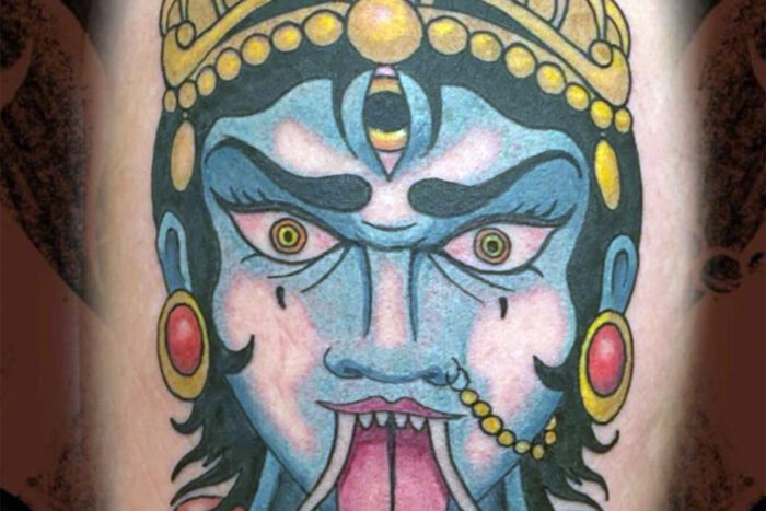 Tattoo of statue face with tongue out