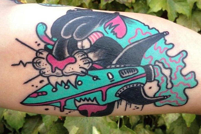 Cougar biting rocket ship tattoo