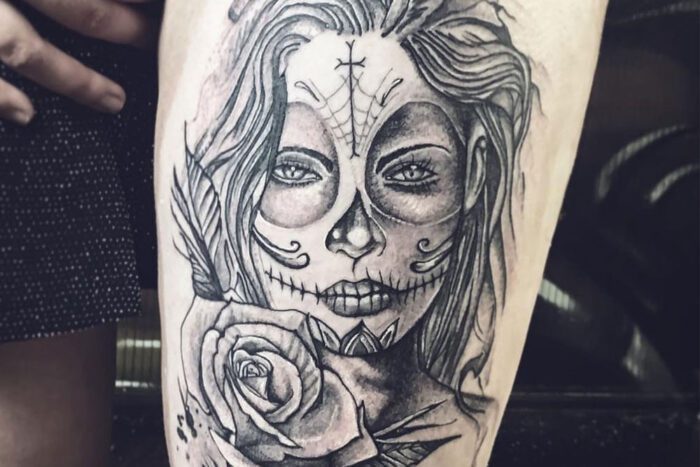 Tattoo of woman's face in surgar skull makeup