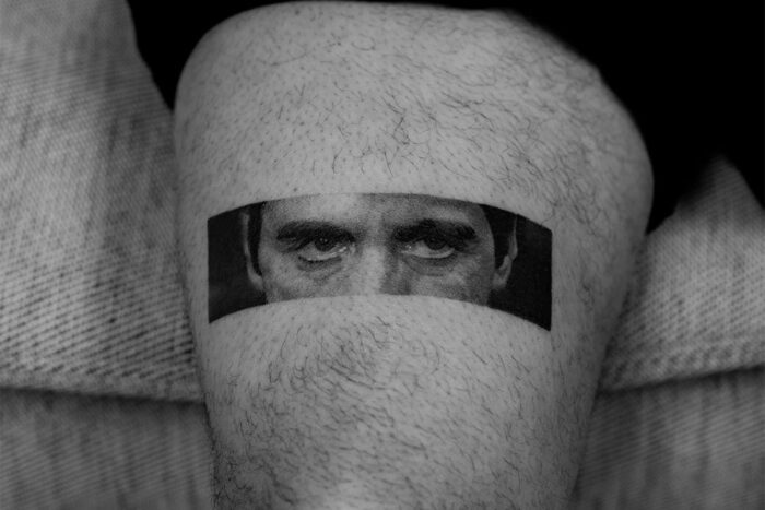 Tattoo of Al Pacino peering through a leg