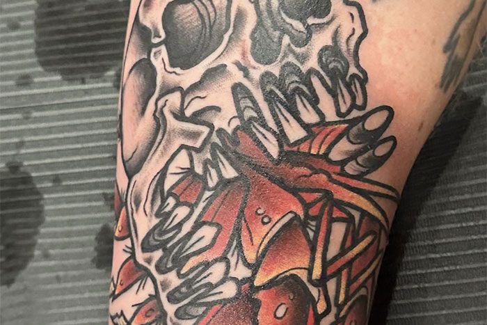 Skull eating lobster tattoo by Stephanie Smash