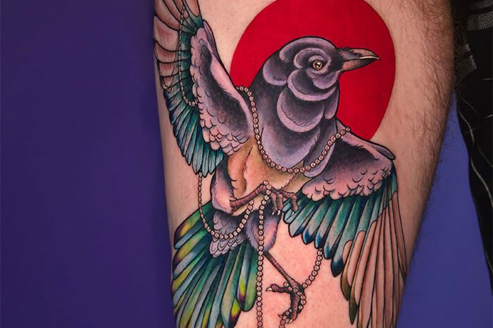 Bird carrying medallion tattoo, by Casja Taylor