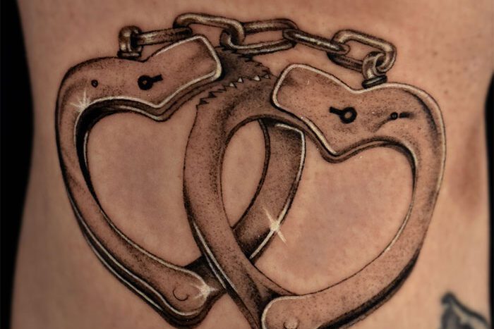 Handcuff tattoo by Elora Perron