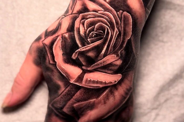 Rose tattoo on hand by Angel Limac