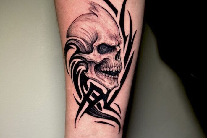 Skull and tribal tattoo by Tara-Lynne Lee