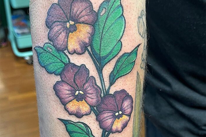 Purple flowers tattoo by Mia Mitchell