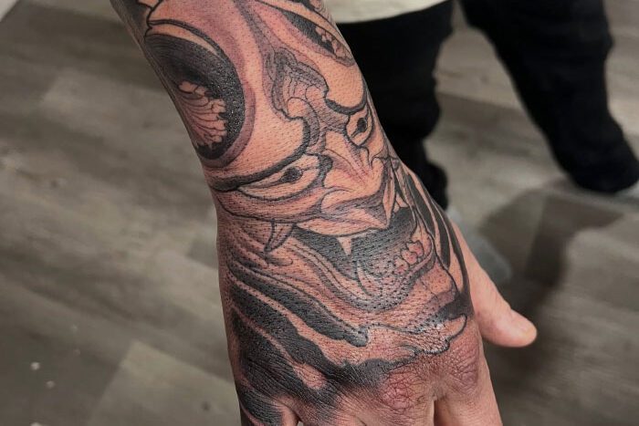 Hand tattoo by Dan Fletcher