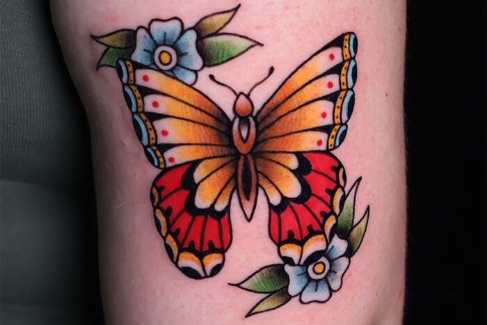 Butterfly and flowers tattoo by Jime Garcés